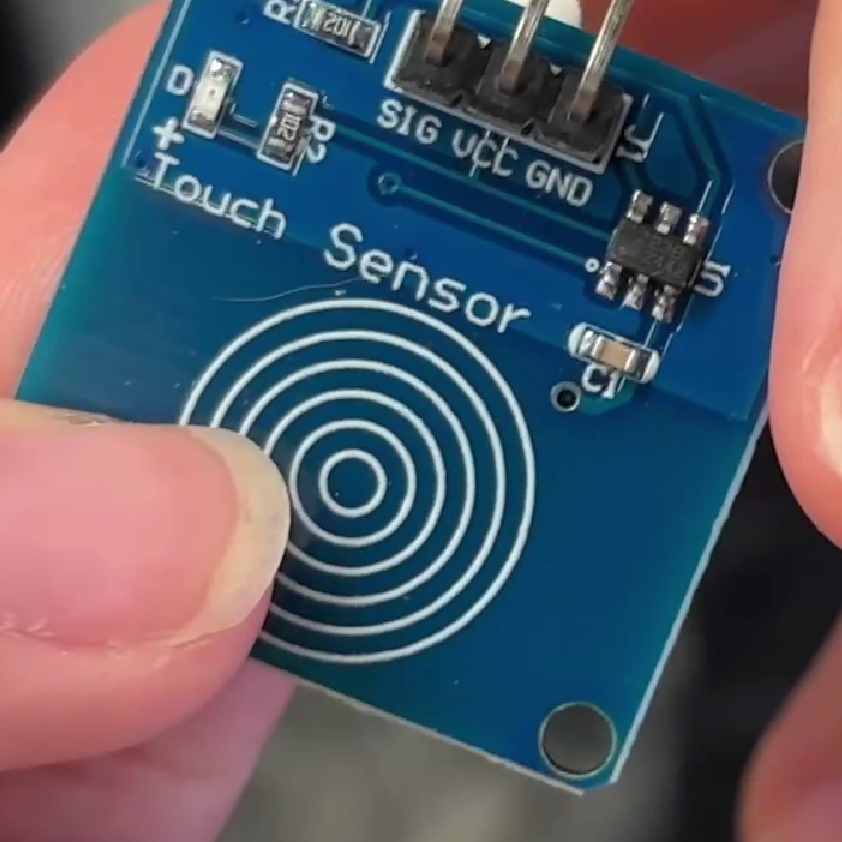 A photo of the touch sensor being tested with a finger touch.